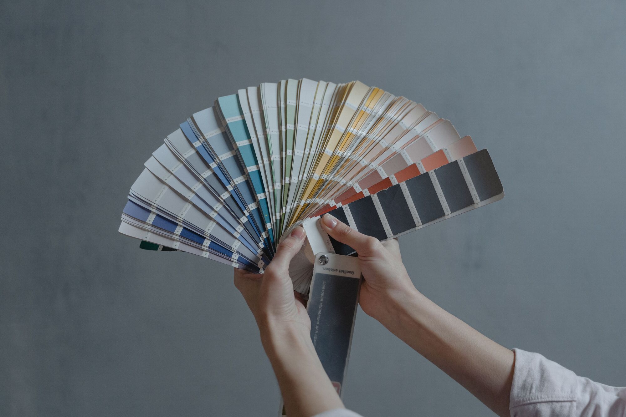 A colour fan deck held against a wall during a consultation